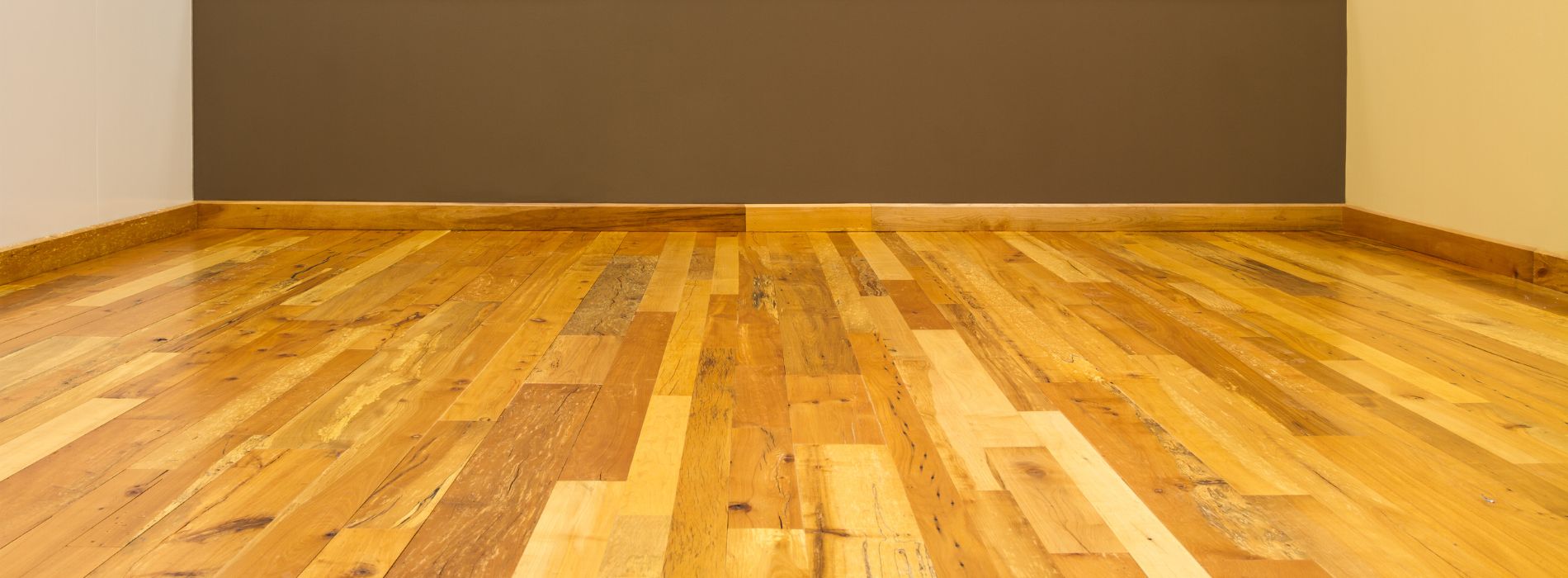 Modern living room in Cannon Street EC2 with gleaming hardwood floors restored by Professional Floor Sanding, complemented by ambient lighting and contemporary furnishings.