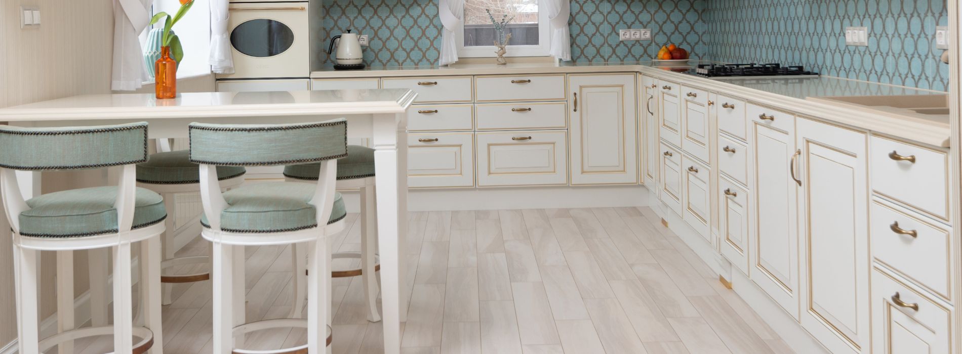 Bright, inviting kitchen with white wooden cabinets, aqua backsplash, and light wood flooring, accented with teal bar stools, showcasing quality sanding in East Sheen, SW14.