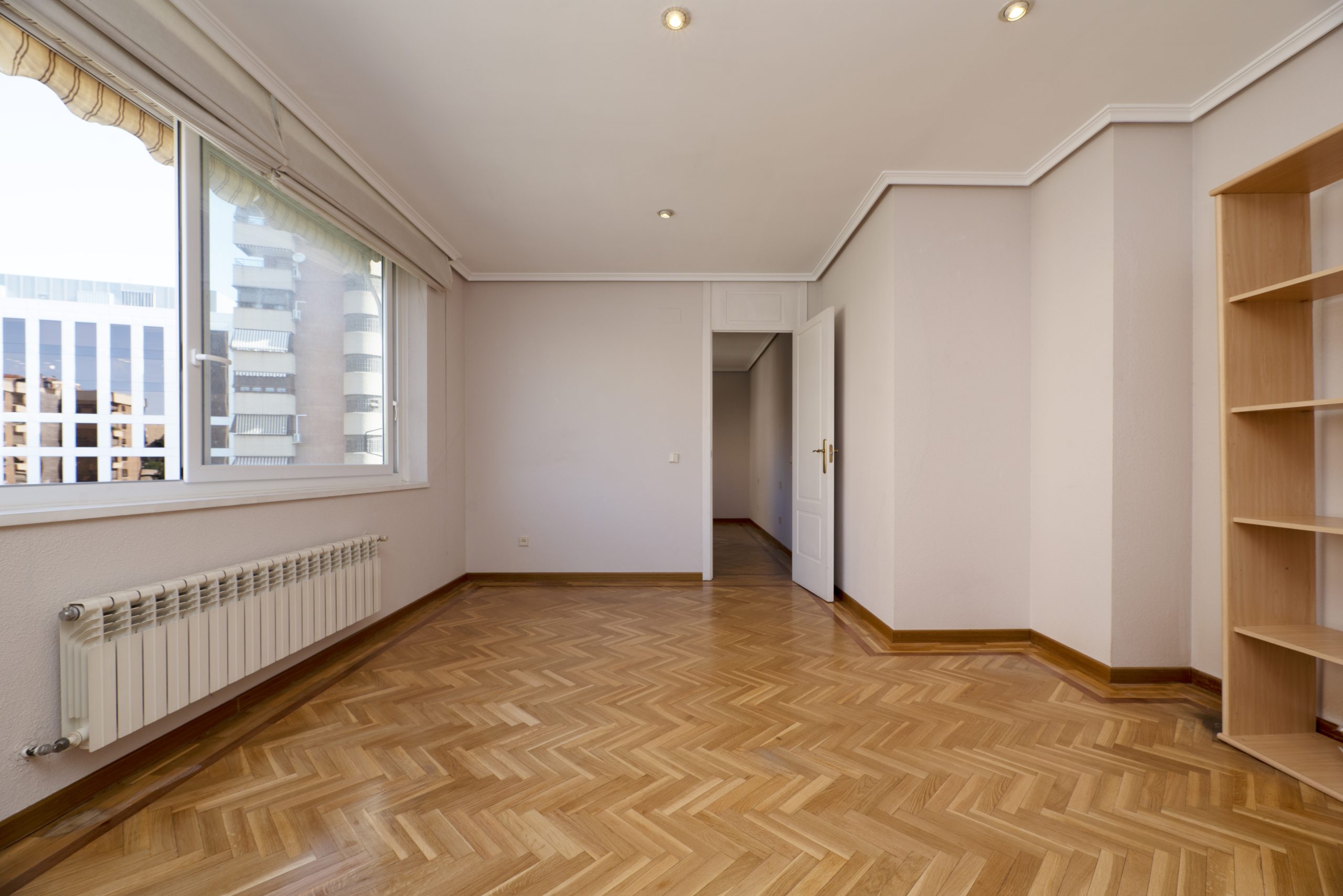 Restored Herringbone Parquet Wood Floor in a Bright Room