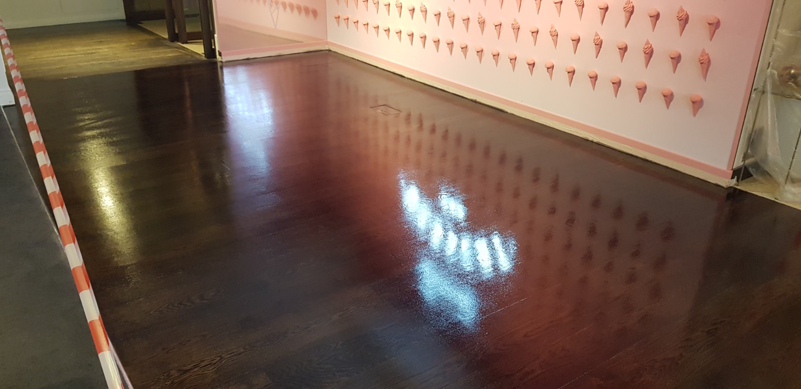 Office Floor Sanding result on dark-stained oak plank hardwood floor, freshly refinished to a high-gloss commercial lacquer.
