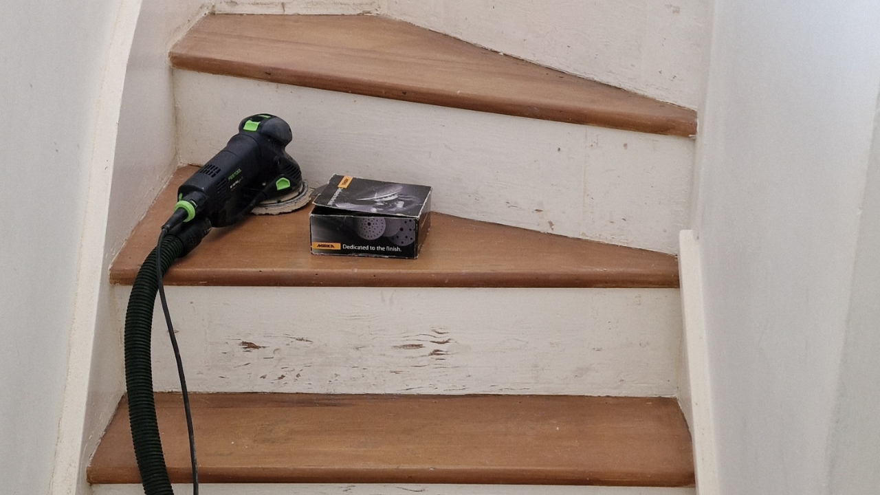 Refinishing Stairs – orbital sander and abrasives on an oak timber hardwood staircase, treads prepped for sanding and anti-slip finishing.